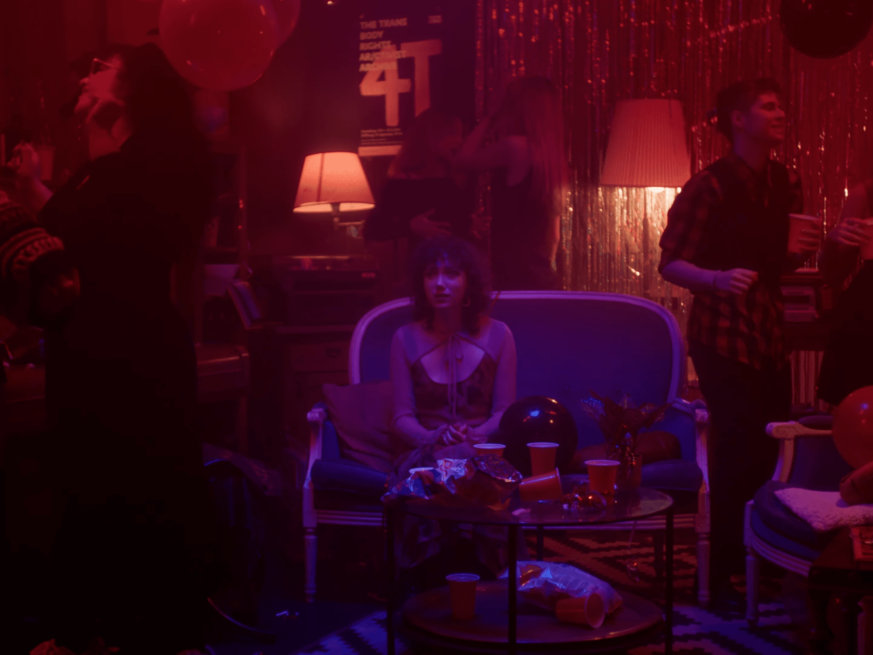 A girl sitting on a couch at a party