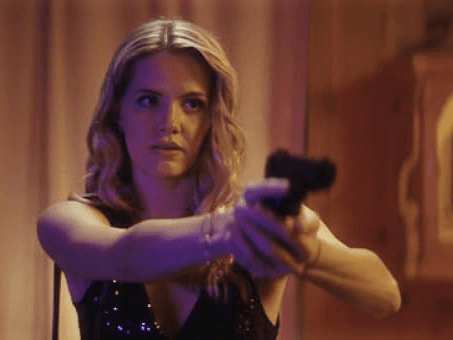 Blonde Woman pointing a gun